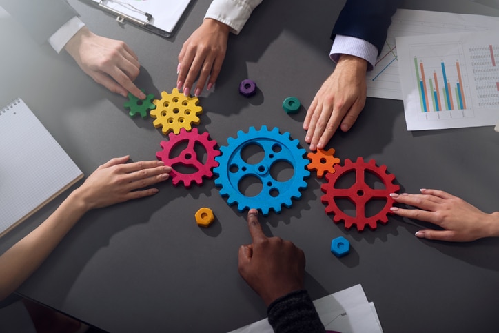 A Guide to Navigating Acquisitions and Divestitures for Oil and Gas Accountants - company teamwork gears - Council of Petroleum Accountants Societies